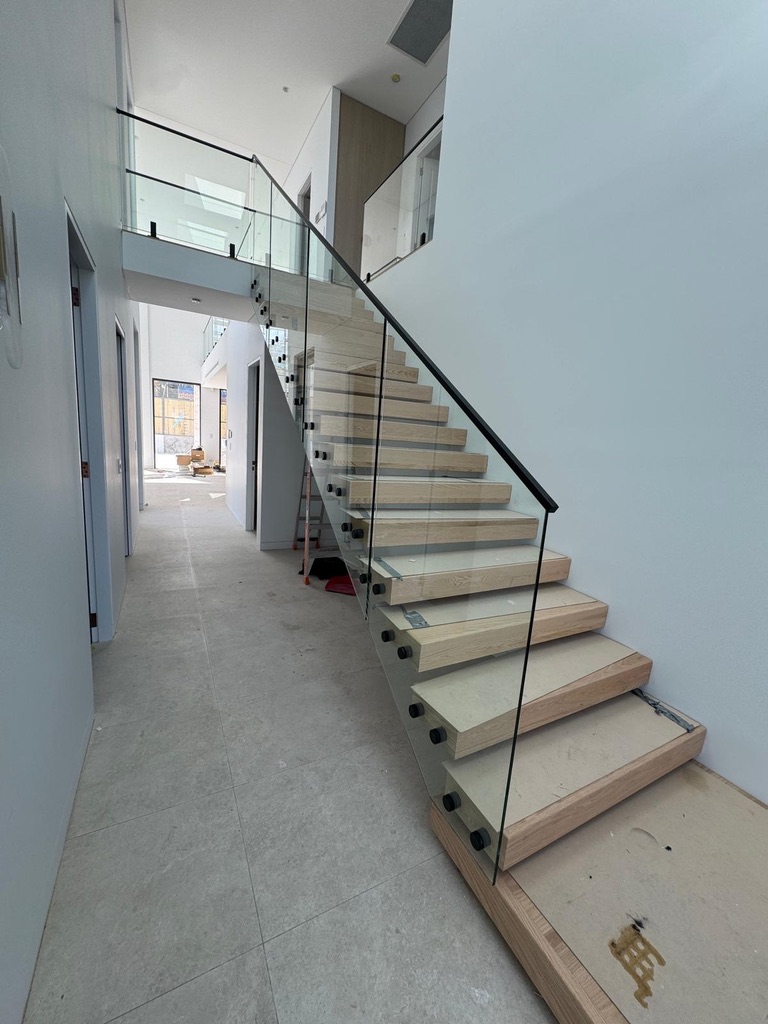 Wrapped staircase with glass balustrade panels