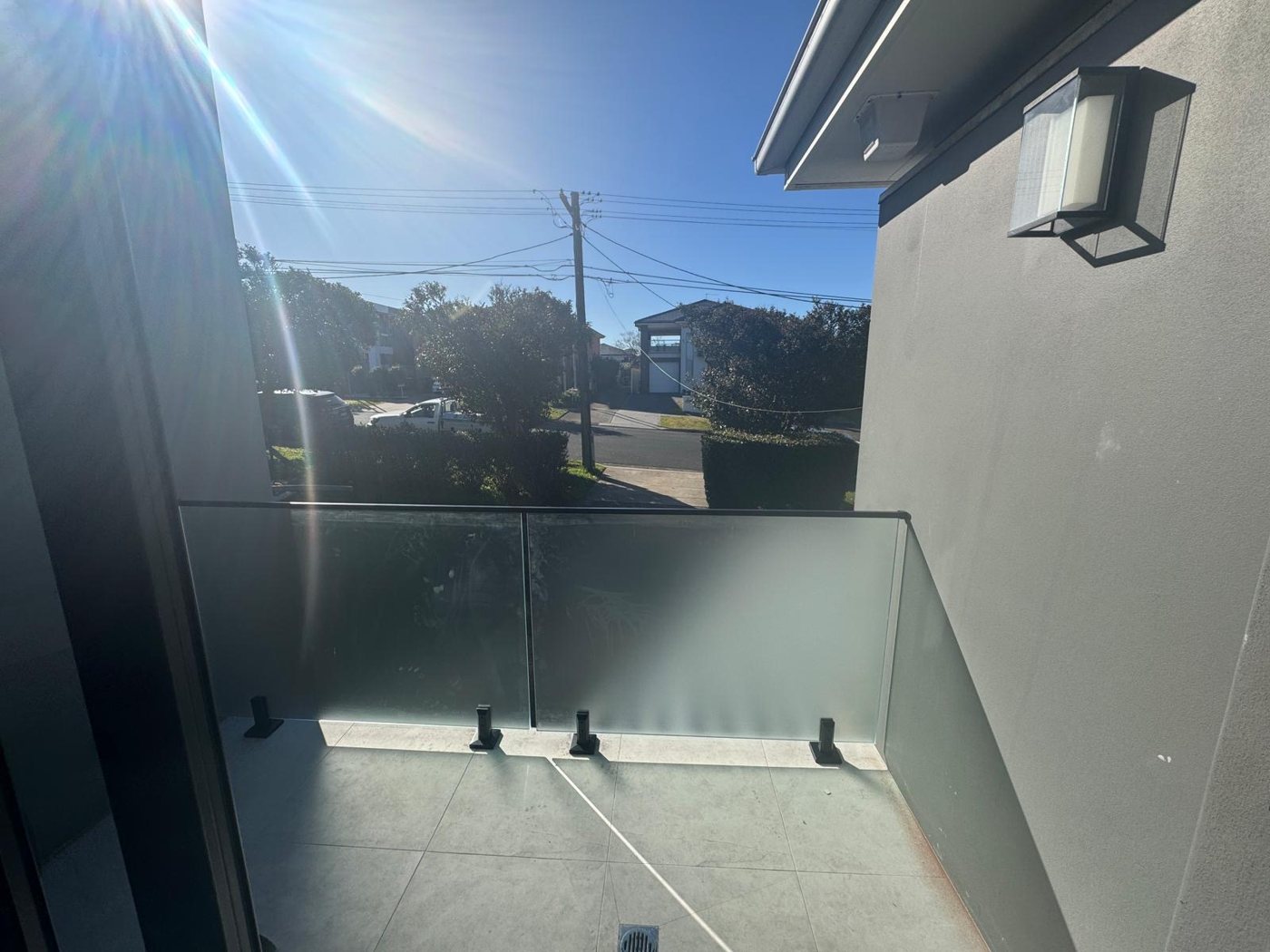 Frosted frameless glass pool-side fence on black spigots