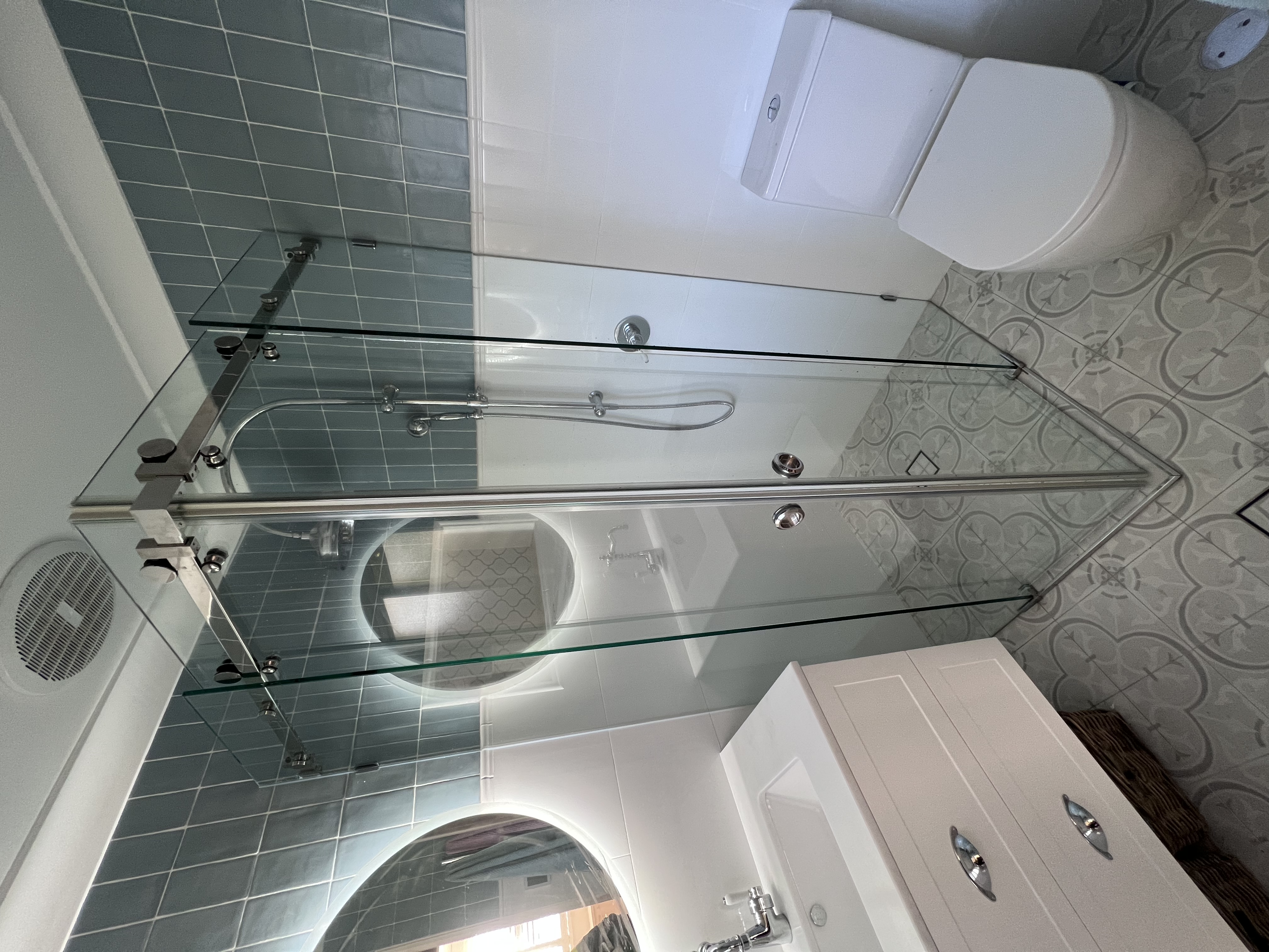 Frameless diamond-corner shower with brushed gold hardware