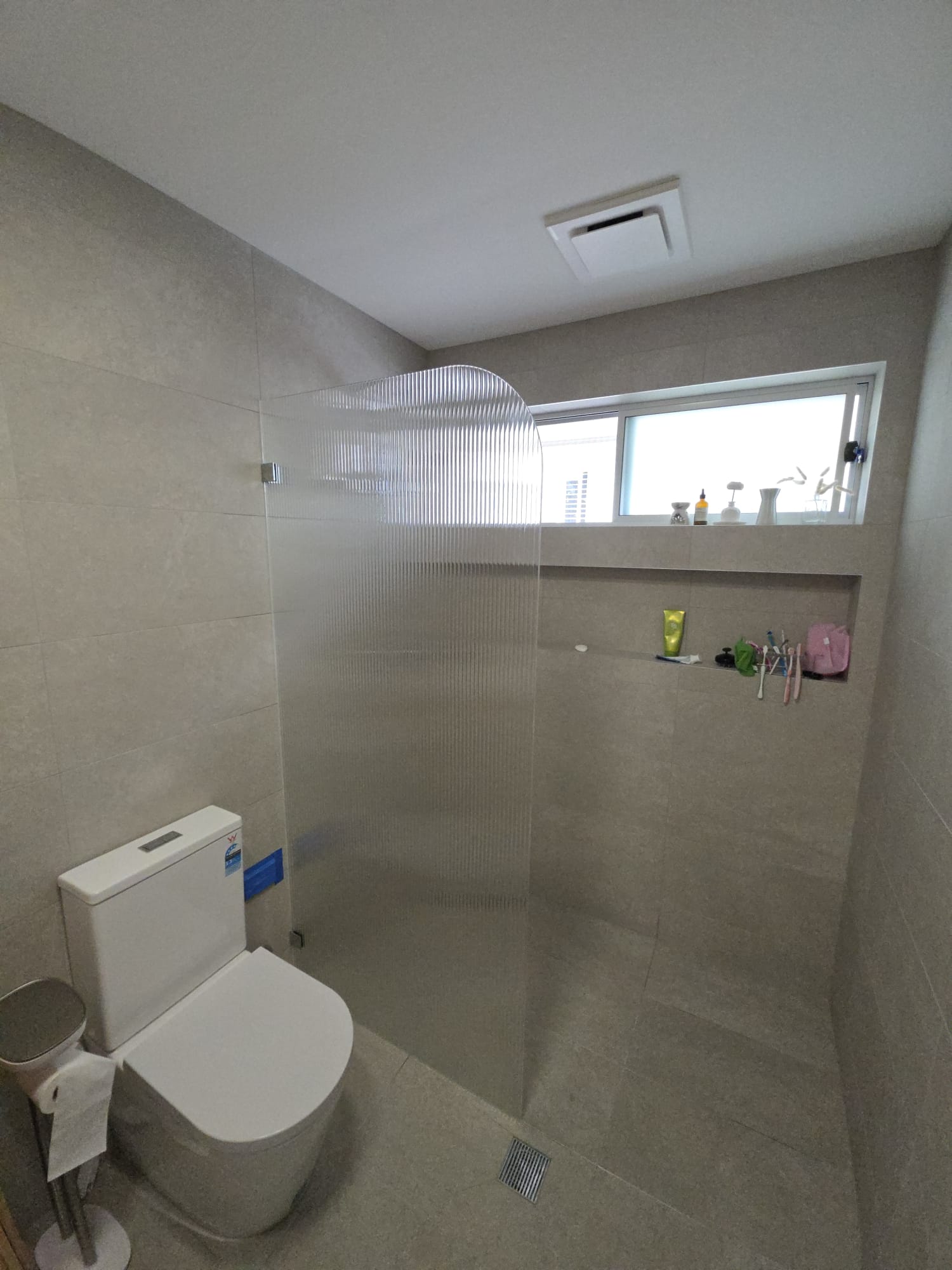 Frameless walk-in fluted shower screen with chrome hardware